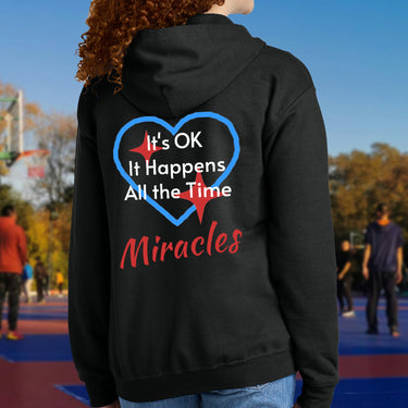 Gildan youth zip-up hoodie with “Miracles Happen” design and uplifting message, Christian apparel made from soft preshrunk fleece, ideal for cooler weather and faith-inspired comfort, teen in black hoodie